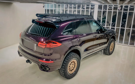 Purple Lifted Porsche Cayenne 958 with off-road tires and roof rack system