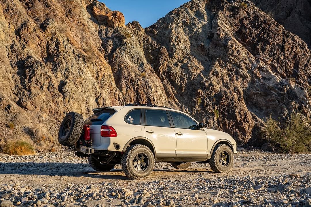 lifted white cayenne 957 gts with akioverland classic fuch offroad wheels in california