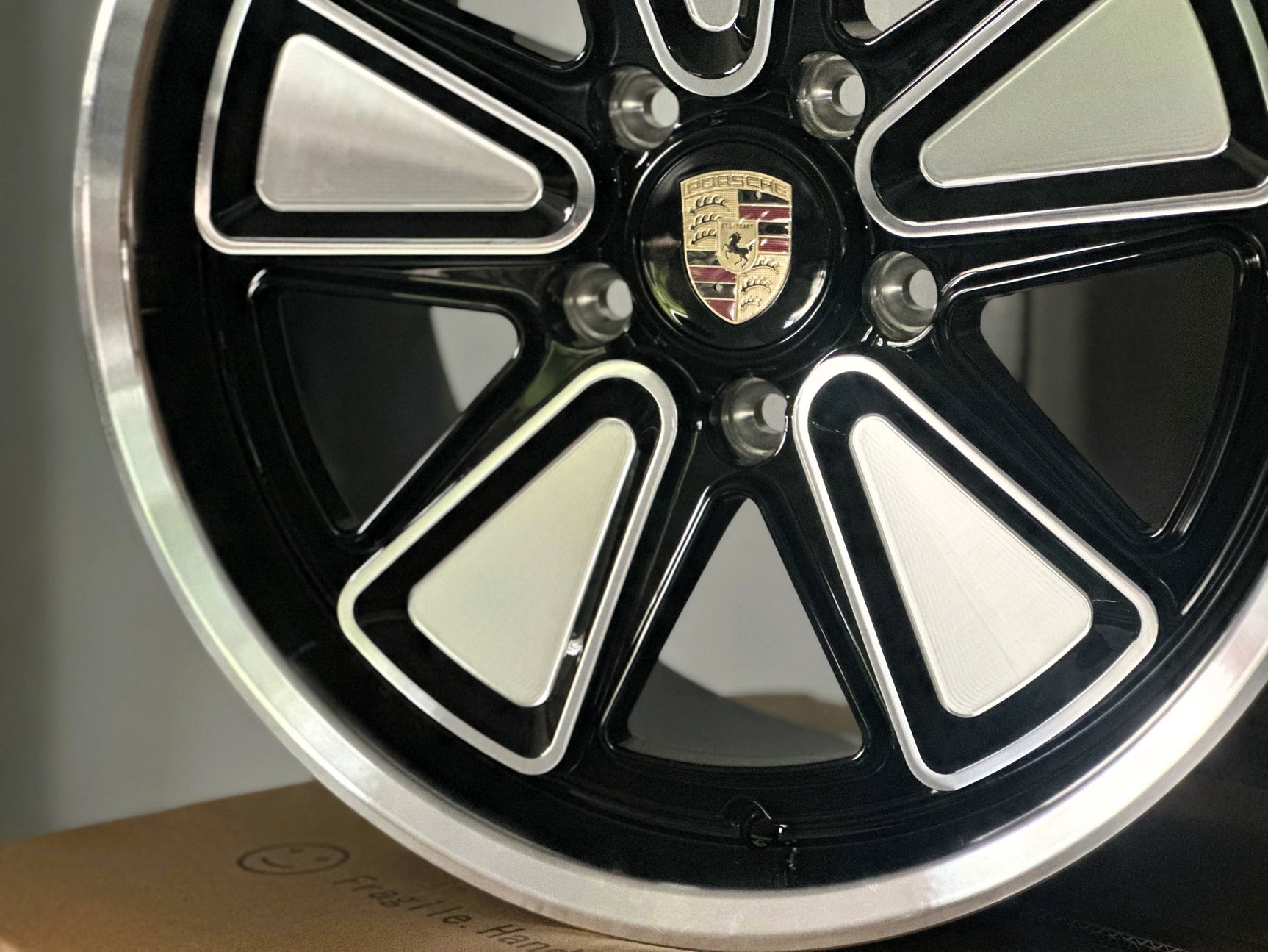 Close-up of Porsche custom forged wheel showing precision CNC-machined surface, reimagined Fuchs design in 5x130 fitment