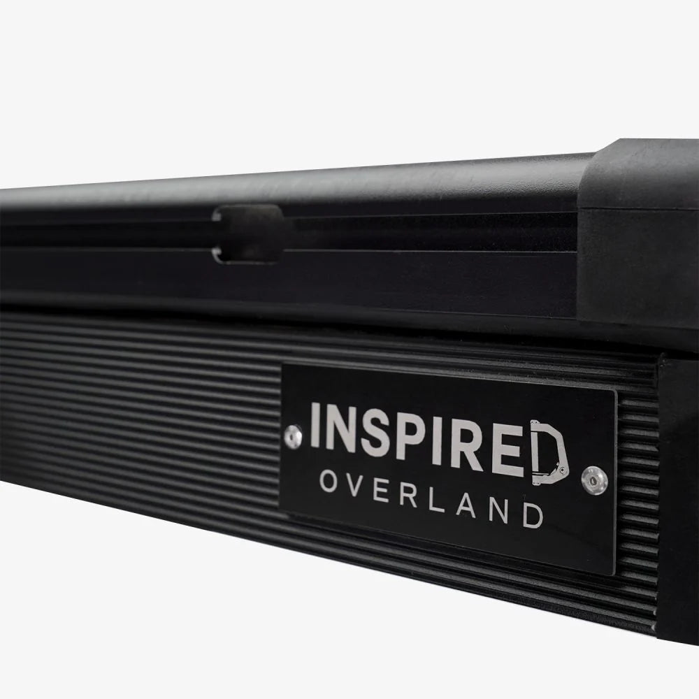 Inspired Overland Carbonlite logo badge on carbon fiber rooftop tent shell