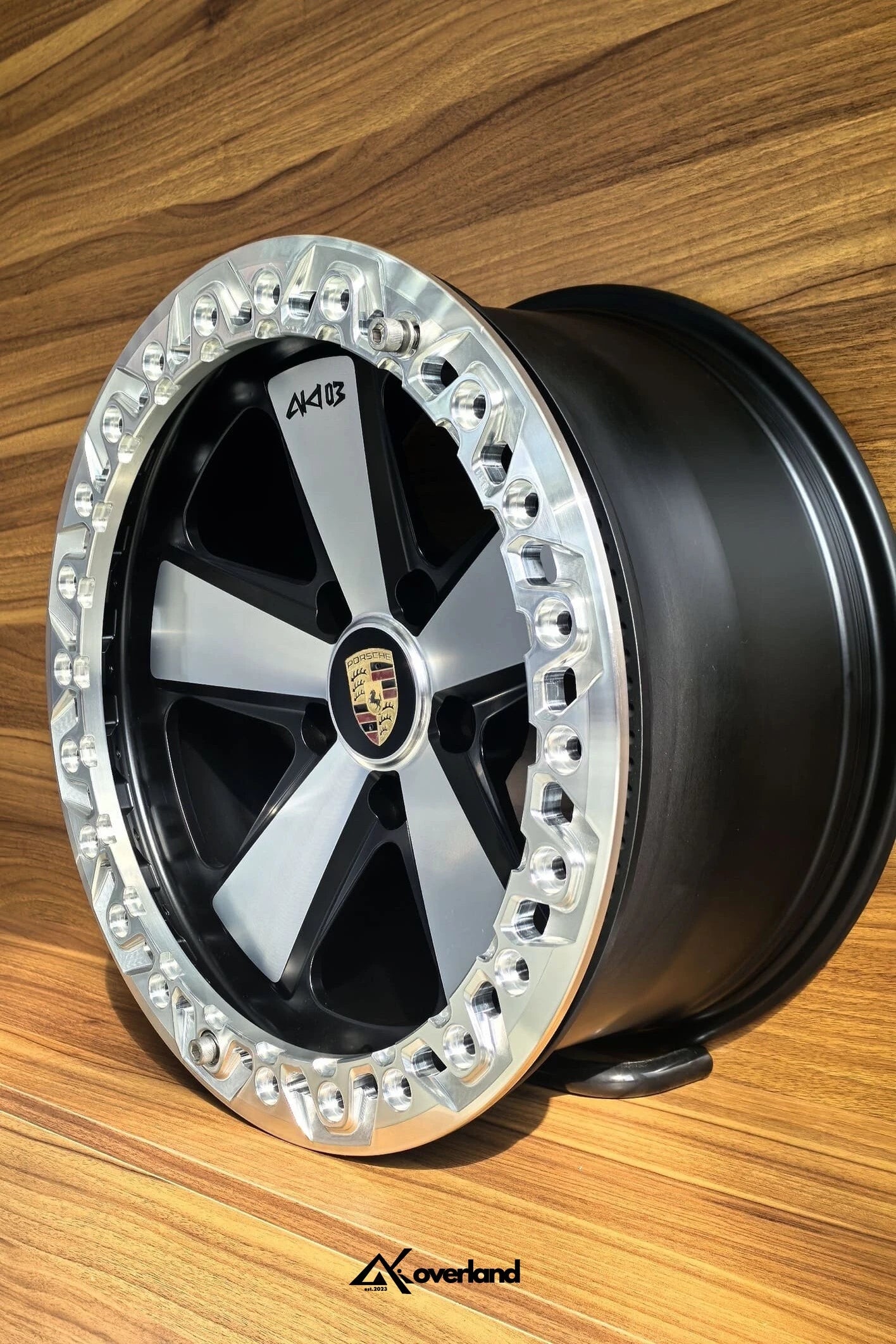 Close-up of forged beadlock Fuchs wheel showing beadlock ring bolts and premium machined finish for Cayenne and Touareg.