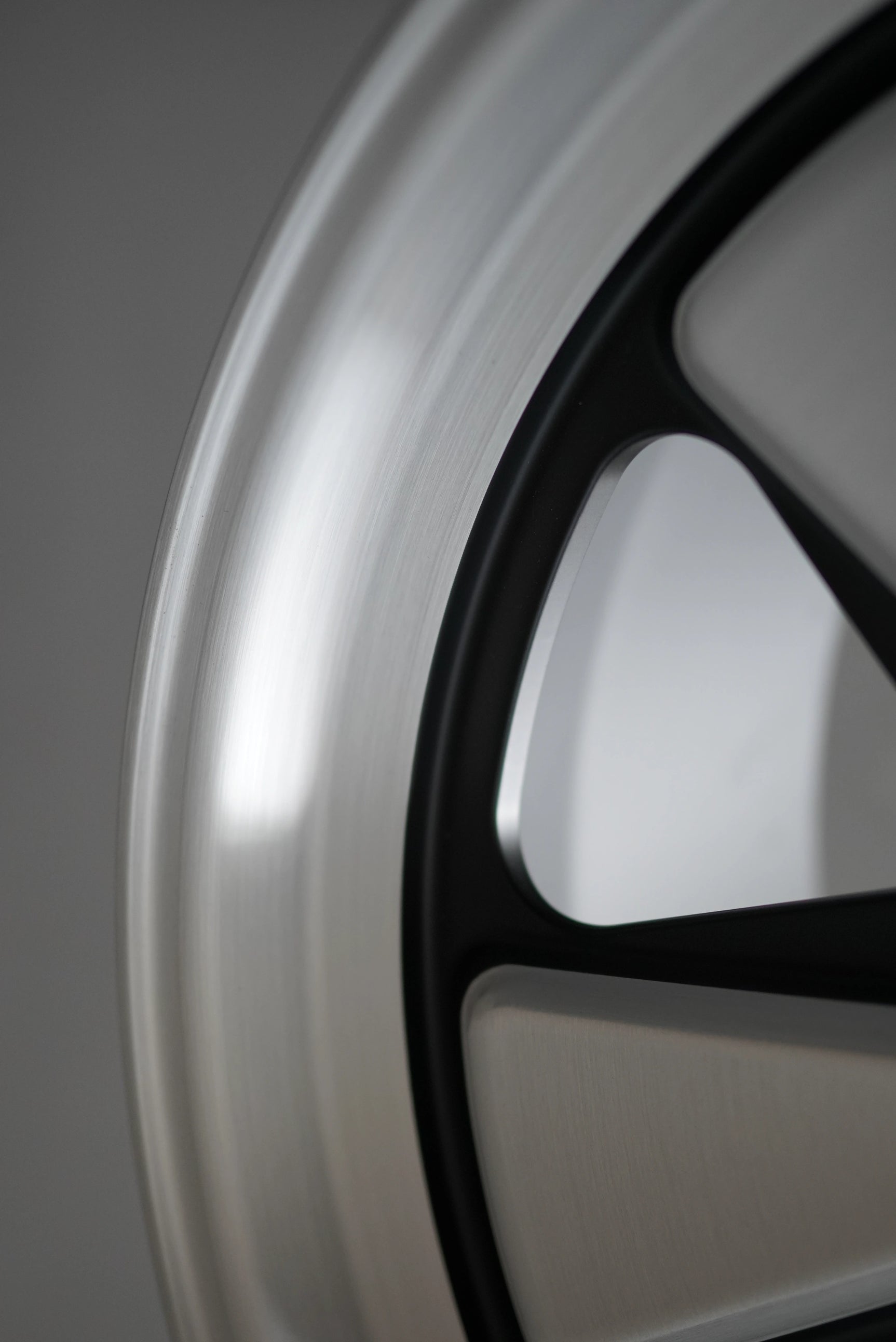 Close-up of brushed aluminum texture on Edition W monoblock forged Porsche wheel.
