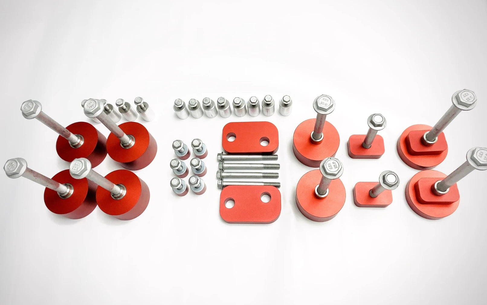 V3 subframe, engine, and transmission drop components with centering sleeves and AKI-stamped hardware.