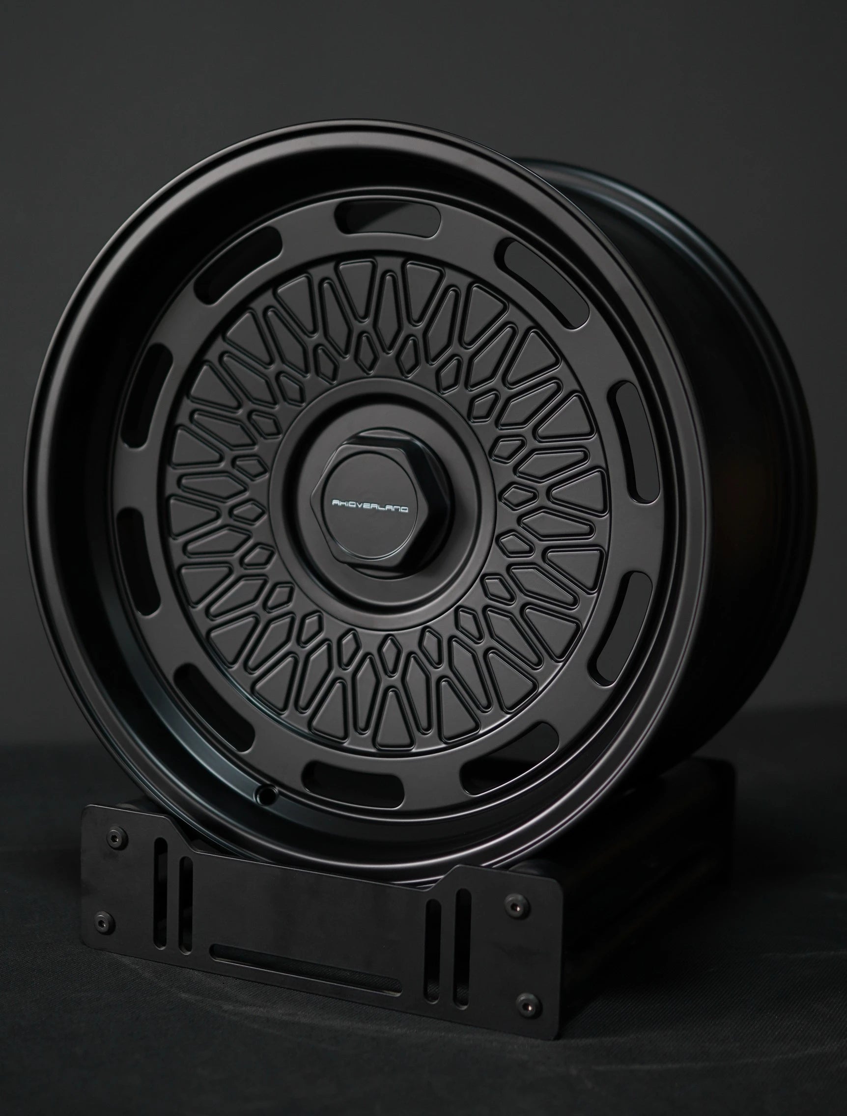 AkiOverland 5x130 mesh wheels in black displayed on stand – ideal offroad and overland wheel choice for Porsche.