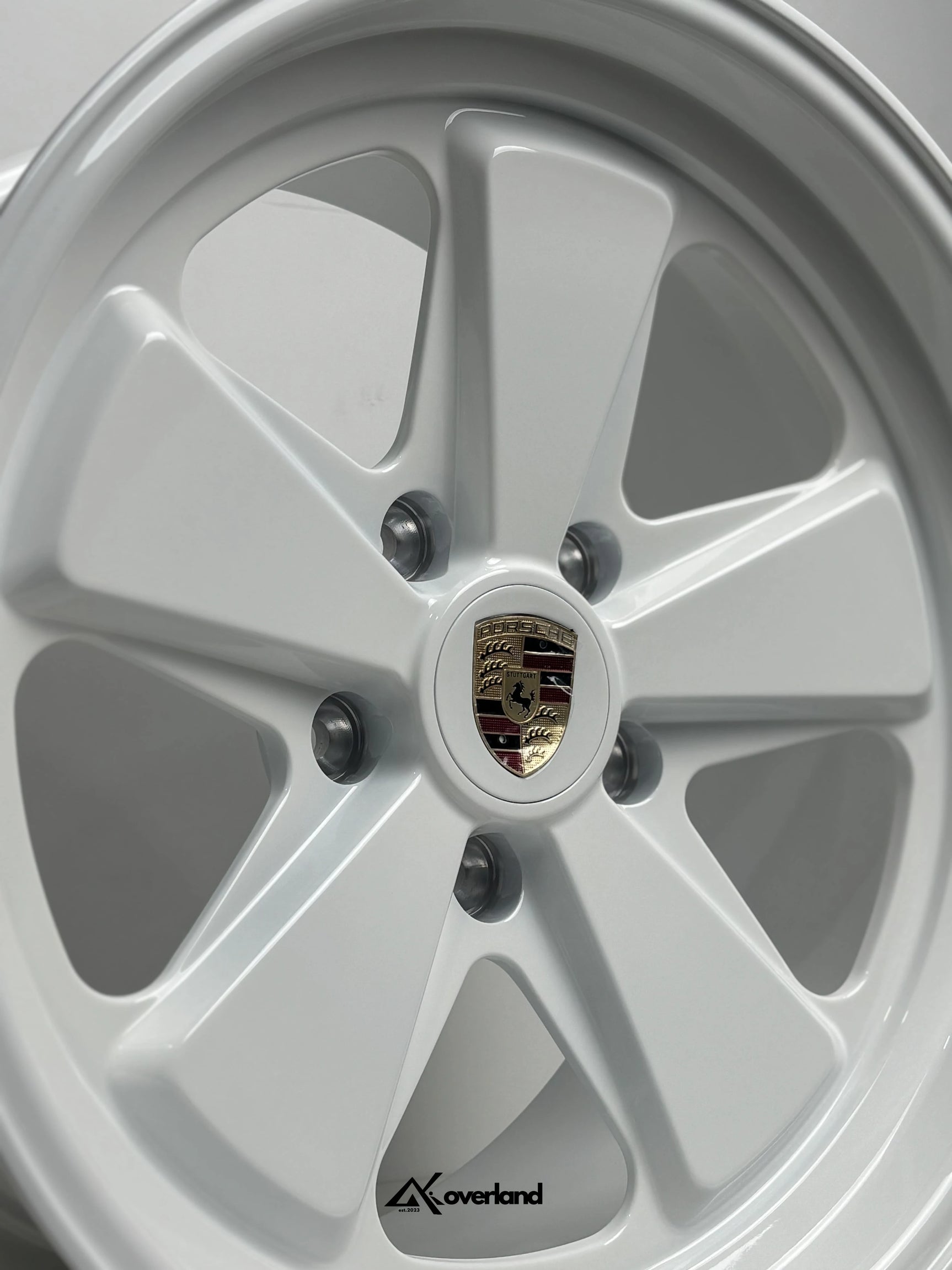 Gloss White Akioverland 5x130 forged wheel with Porsche crest, premium off-road fitment for Cayenne, Touareg, and Q7.