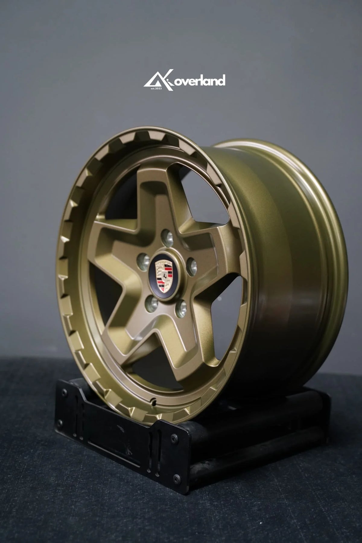 Akioverland 5x130 Forged Cookie Cutter Rugged wheel in special Bronze with Hidden Green finish, three-quarter view showing face and barrel