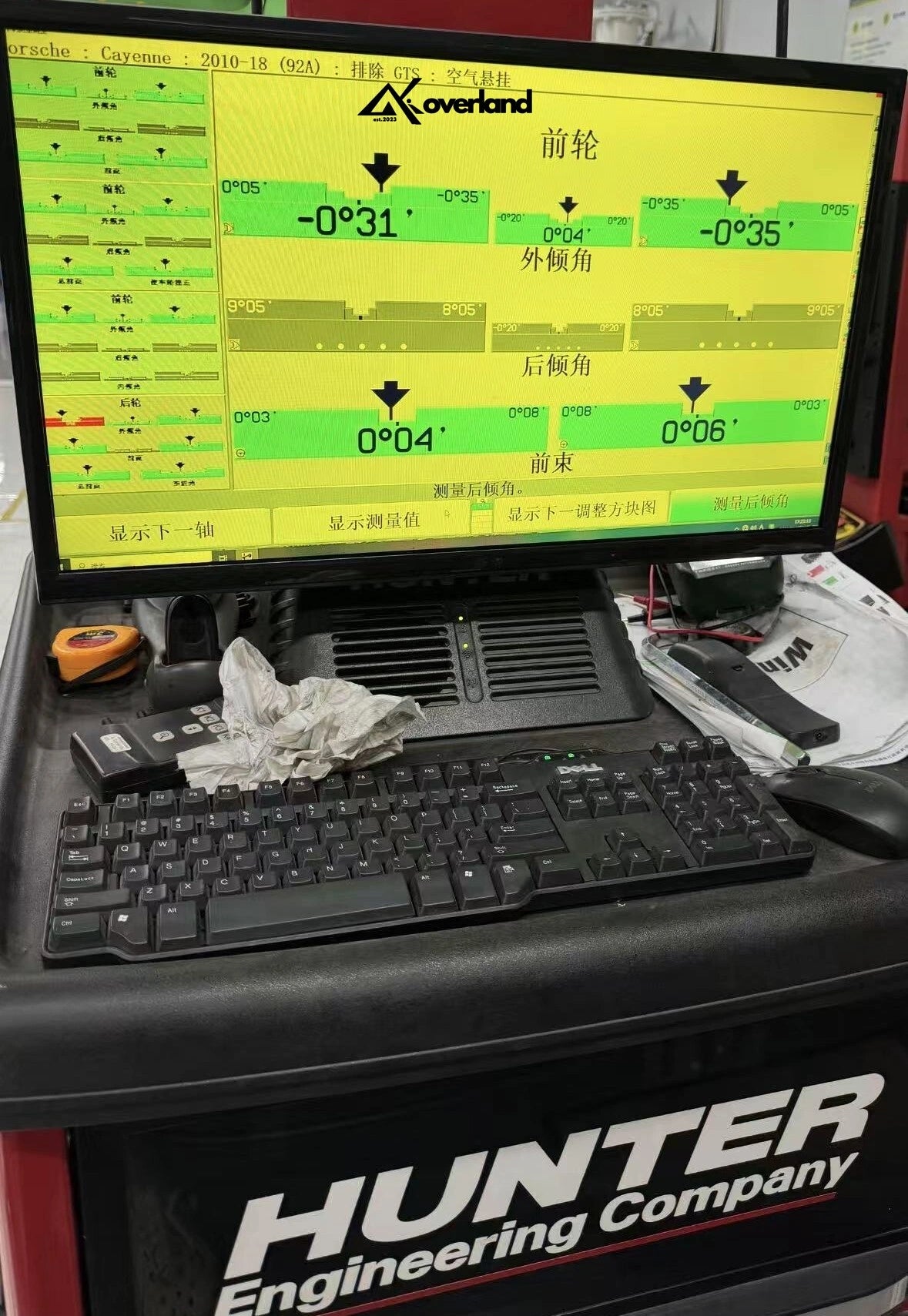 Porsche Cayenne 958 GTS with Akioverland 3-inch air lift kit showing perfect camber and toe alignment on a Hunter Engineering alignment machine.