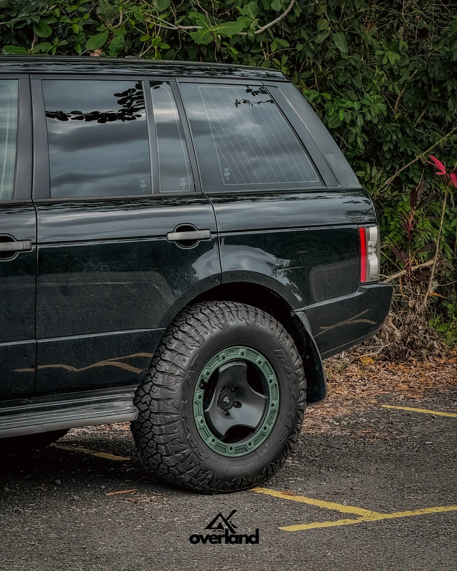 Rear quarter view of lifted Range Rover L322 with 5x120 trispoke forged off-road wheels and expedition setup.