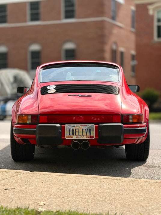 Straight rear view of 1982 Porsche 911 SC in Ohio showing Dansk center-exit dual exhaust tips and AkiOverland Fuchs Reimagined 5x130 wheels