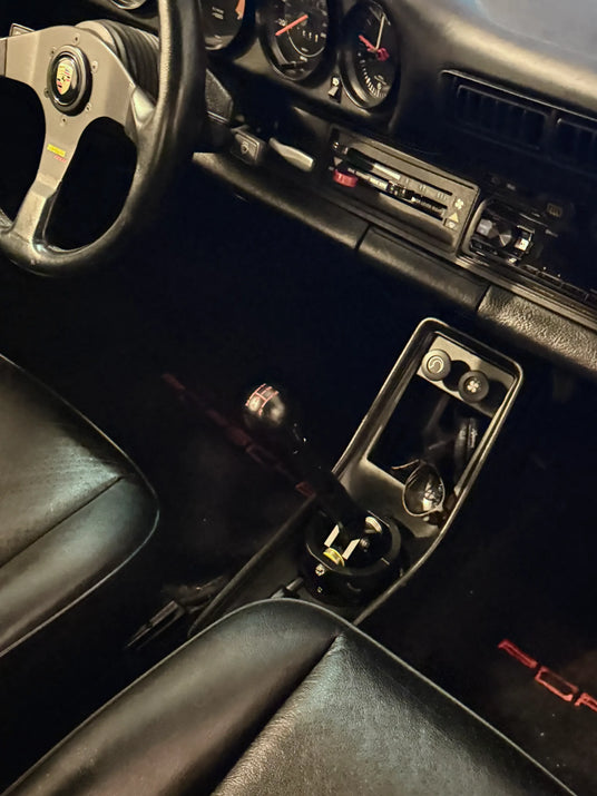 1982 Porsche 911 SC interior showing Numeric Racing short-throw shifter, Momo steering wheel and original SC dashboard gauges