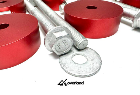 CNC spacers and V1 subframe blocks arranged with AKI-stamped bolts for 2.5-inch lift kit