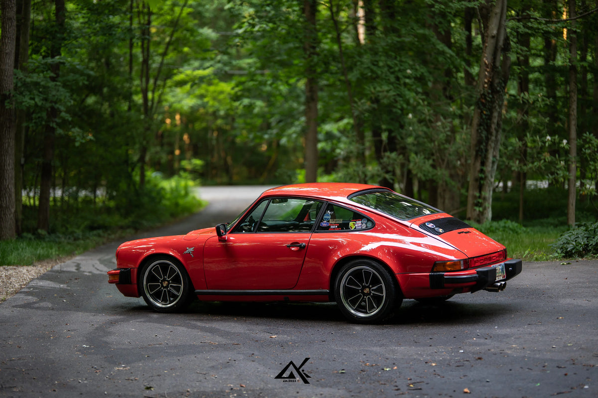 Classic Porsche 911 SC G Body rear three-quarter view with AkiOverland Fuchs Reimagined wheels