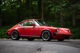 Side profile of lowered red Porsche 911 SC G Body with Fuchs Reimagined custom wheels