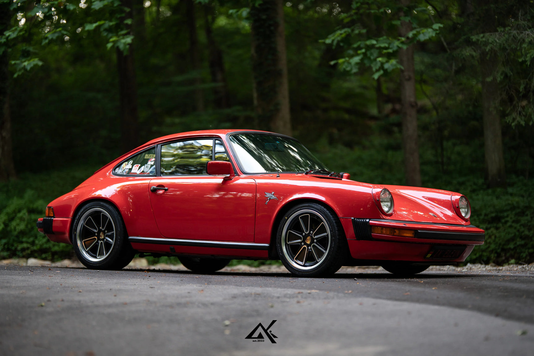 Side profile of lowered red Porsche 911 SC G Body with Fuchs Reimagined custom wheels