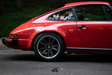 Rear quarter detail of Porsche 911 SC G Body showing AkiOverland Fuchs Reimagined custom wheel fitment

911-6