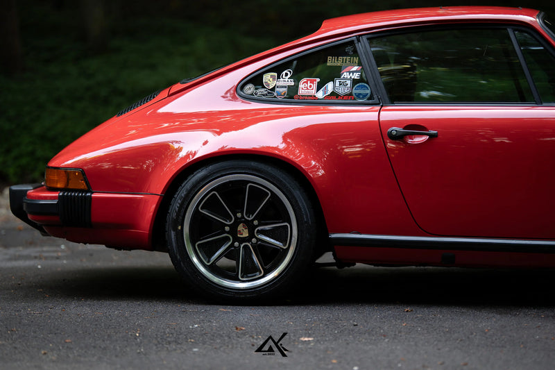 Rear quarter detail of Porsche 911 SC G Body showing AkiOverland Fuchs Reimagined custom wheel fitment

911-6