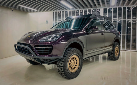 Porsche Cayenne 958 overland build. With offroad tires, tubular front bumper and super slim roof rack in showroom settings. 