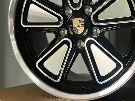 Close-up of Porsche custom forged wheel showing precision CNC-machined surface, reimagined Fuchs design in 5x130 fitment