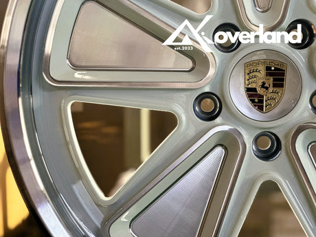 Detailed CNC machining on reimagined Fuchs forged Porsche wheel, highlighting sharp edges and precision metal finishing