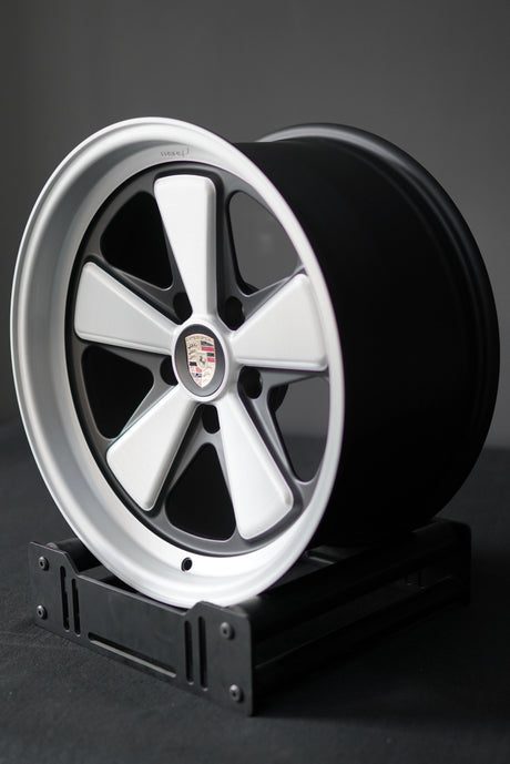 Porsche 5x130 Edition W forged wheel with brushed face and satin windows photographed on stand.