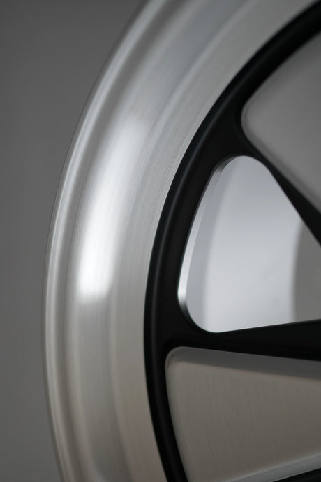 Close-up of brushed aluminum texture on Edition W monoblock forged Porsche wheel.