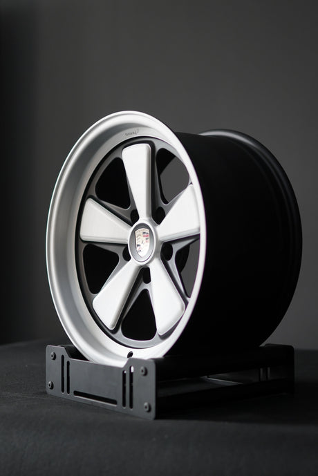 Brushed details on Porsche 5x130 Edition W wheel showcasing deep spoke curvature and modern Fuchs styling.