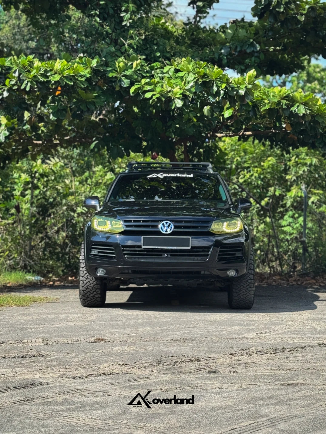Lifted VW Touareg 7P with widebody fenders running Akioverland 2.5-inch spring lift kit and V3 subframe, engine, and transmission drop system for corrected geometry.
