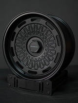 AkiOverland 5x130 mesh wheels in black displayed on stand – ideal offroad and overland wheel choice for Porsche.