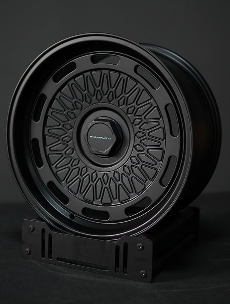 AkiOverland 5x130 mesh wheels in black displayed on stand – ideal offroad and overland wheel choice for Porsche.