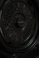 Studio shot of AkiOverland 5x130 mesh wheels in black – premium forged wheels for Porsche offroad builds.