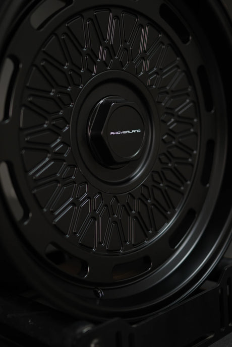 Studio shot of AkiOverland 5x130 mesh wheels in black – premium forged wheels for Porsche offroad builds.