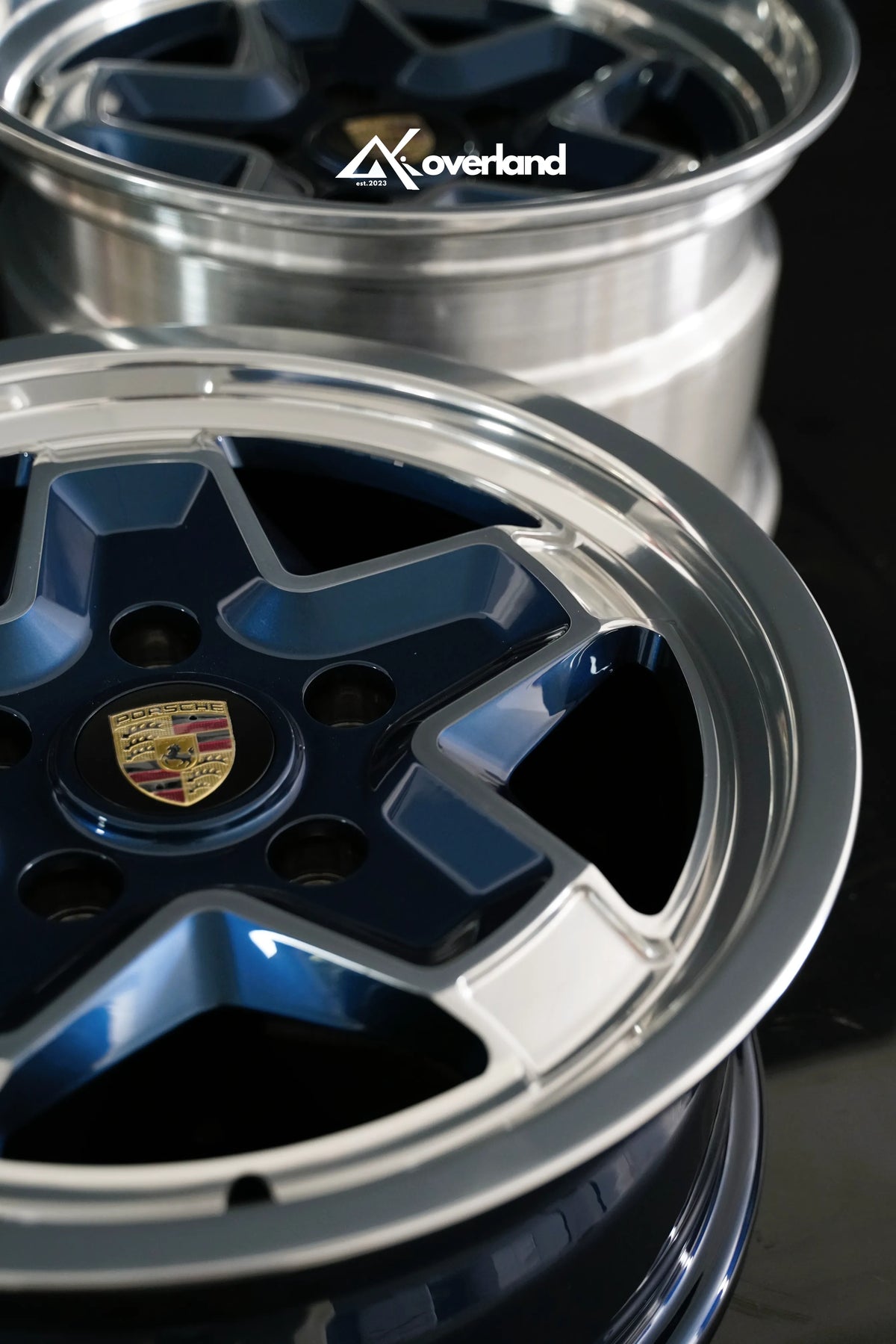 2-piece forged cookie cutter wheel by AkiOverland, deep machined polished lip and midnight blue face, 5x130 Porsche