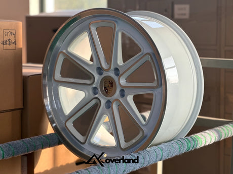 Akioverland 5x130 Fuchs Reimagined forged wheel in metallic white, with clean CNC machining lines and a premium finish