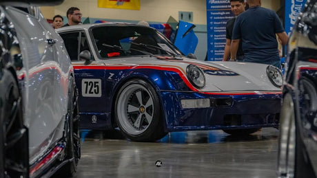 Deep-lip AkiOverland VLD 2-piece Fuchs wheels on widebody Porsche 964 in livery