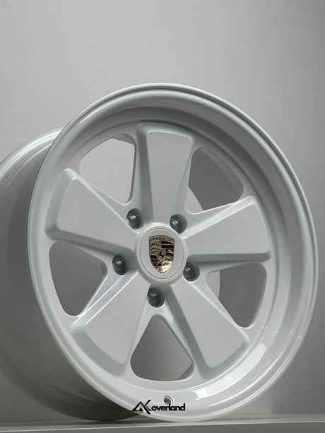 White Akioverland 5x130 forged wheel with Porsche crest, premium off-road fitment for Cayenne, Touareg, and Q7.