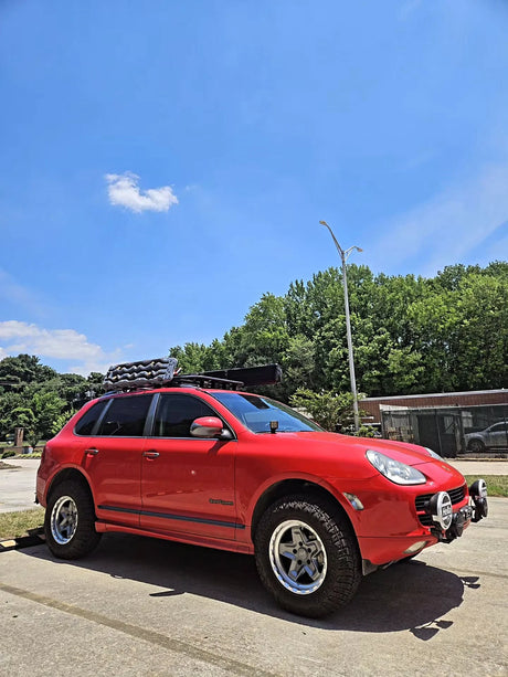 Red Porsche Cayenne 955 fitted with AkiOverland 5x130 Forged Cookie Cutter Rugged wheels in 2 Tone machined and grey finish
