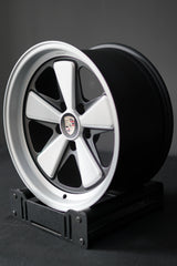 AkiOverland Edition W 5x130 forged wheel with brushed face and satin windows, photographed on a stand