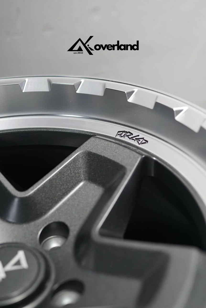 Akioverland 5x130 Forged Cookie Cutter Rugged wheel in 2 Tone finish, close-up of the engraved FORGED lip detail