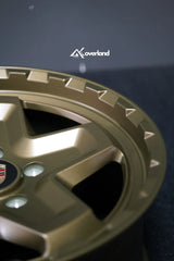 Akioverland 5x130 Forged Cookie Cutter Rugged wheel in special Bronze with Hidden Green finish, close-up of the engraved FORGED lip detail