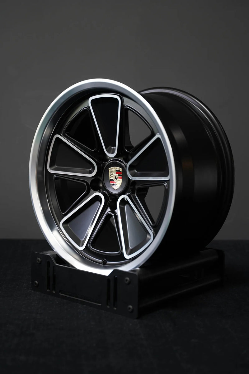 AkiOverland 5x130 Fuchs Reimagined forged wheel studio shot — matte black with machined finish and polished lip for Porsche 911 Cayenne Touareg
