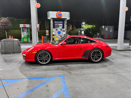 Side profile of a red Porsche 997 on AkiOverland Fuchs Reimagined custom forged wheels showing fitment