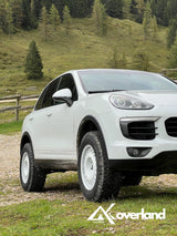 Lifted Porsche Cayenne 958 with Akioverland spring suspension system, increased ground clearance, and rugged off-road wheel setup for overlanding