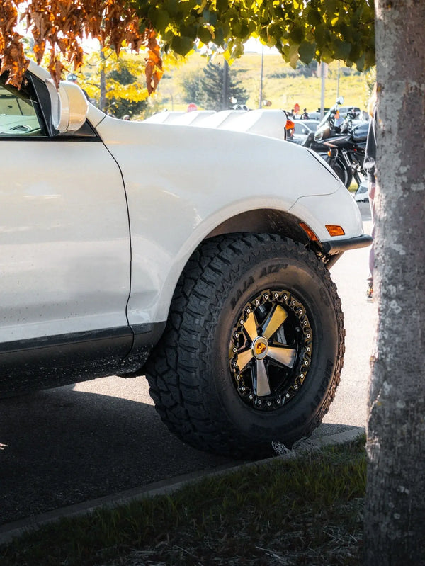 Porsche Cayenne 957 with 5x130 Beadlock Fuchs off-road wheel, functional beadlock ring, and aggressive all-terrain tire fitment.