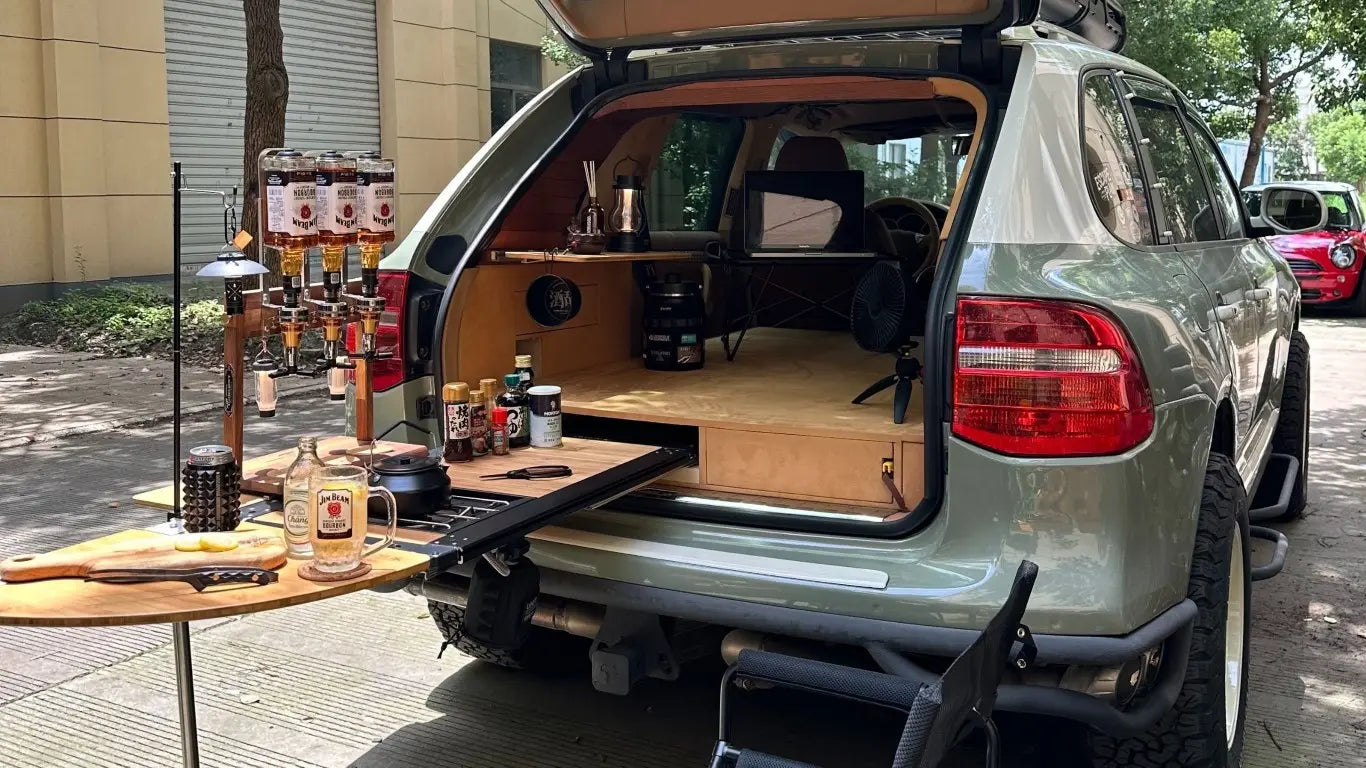 Akioverland rear drawer system installed in Porsche Cayenne 955/957 with slide-out table and overland storage layout.