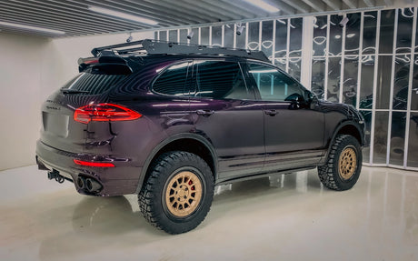 Porsche Cayenne 958 overland build. With offroad tires, tubular front bumper and super slim roof rack in showroom settings. 