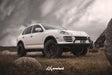 Porsche Cayenne 957 diesel off-road build with AkiOverland 2.5 inch spring lift kit, subframe drop and steel tubular front bumper with winch mount, photographed in Australia