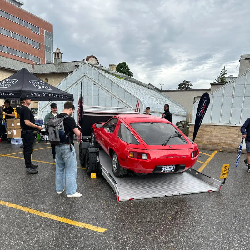 Classic Porsche 928 arriving at a Cars & Coffee event, celebrating Porsche heritage and inspiring modern Porsche Macan builds with Akioverland Edition W Forged Fuchs wheels.