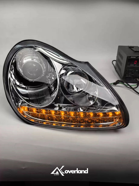 Porsche Cayenne 955 LED projector headlight showing amber turn signal and upgraded lighting design.