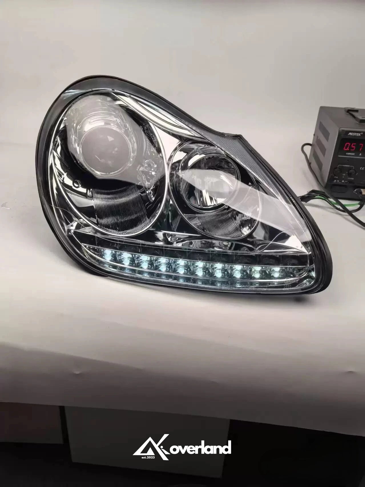 Porsche Cayenne 955 LED projector headlight with white daytime running light upgrade.