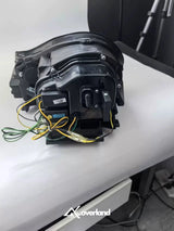 Rear wiring view of Porsche Cayenne 955 LED projector headlight showing connector and installation harness.